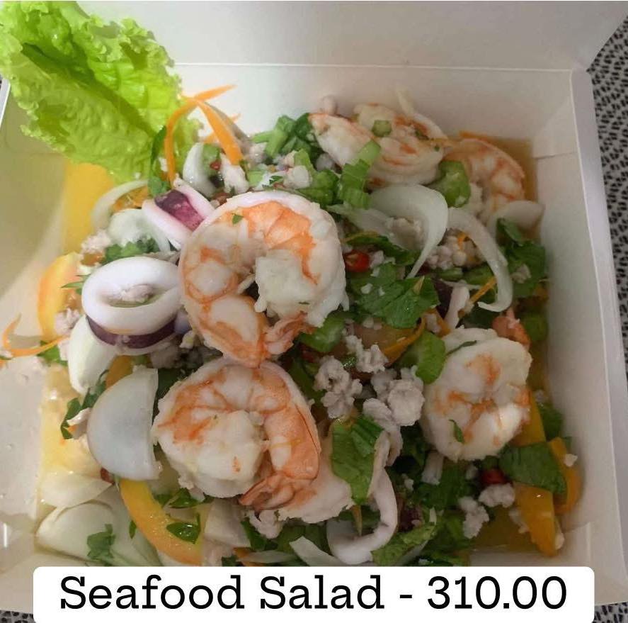 Thai salad dish — fresh herbs and vegetables with tangy Thai dressing