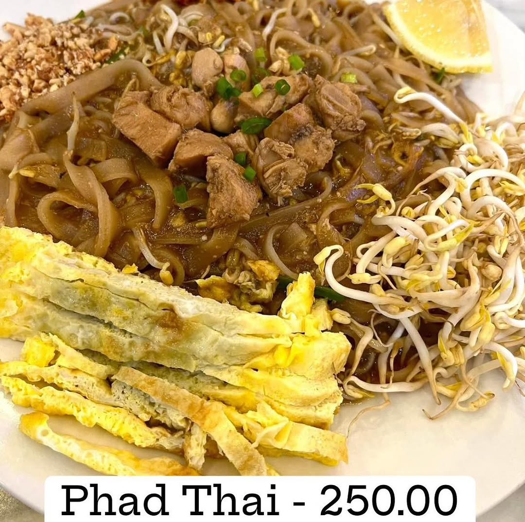 Thai food variety — grilled chicken and fresh greens on a platter